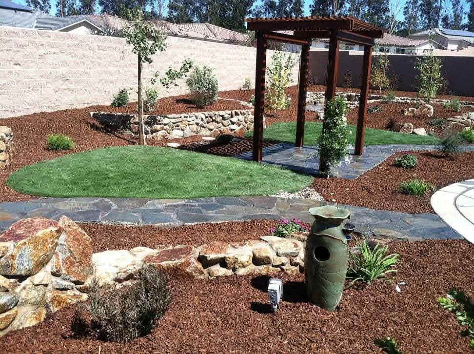 Pergola, flagstone paths, oval lawns, and tiered planting