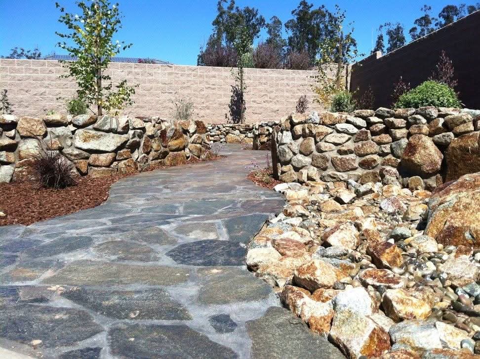 Flagstone walkway with stone walls and dry creek bed